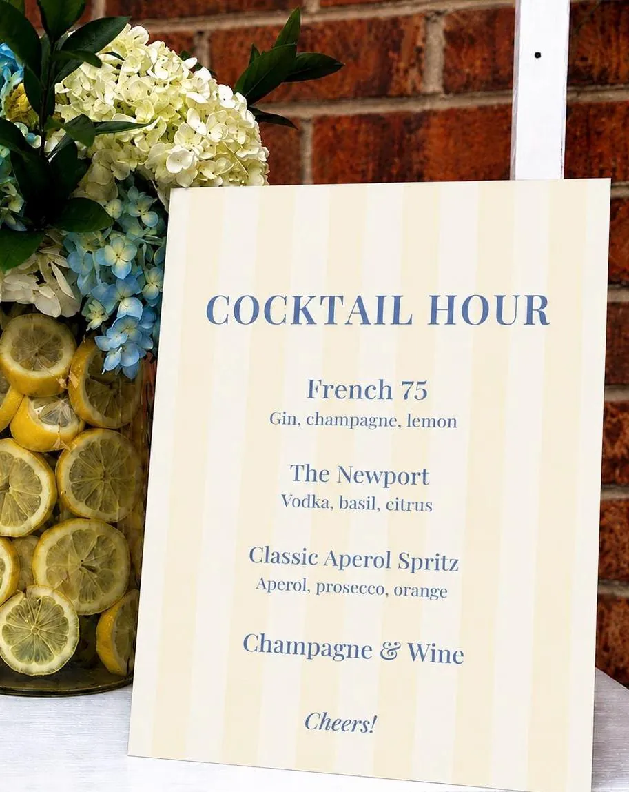 A French blue striped cocktail menu sign with hydrangeas and lemons