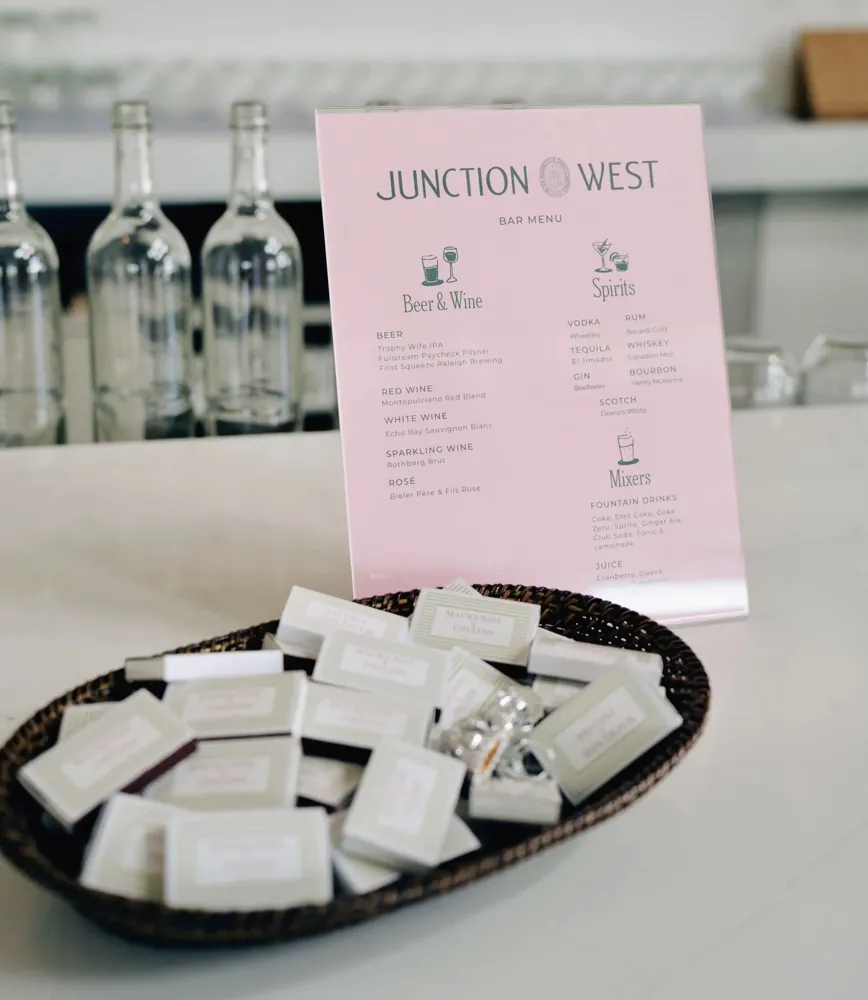 A pink bar menu with a basket of matchbox favors