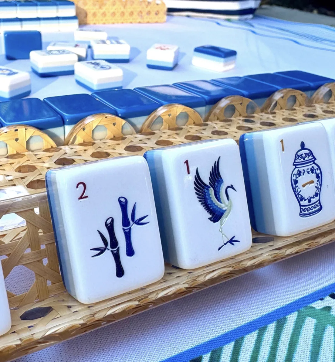 A complete Mahjong table with racks, green tiles and a mat, seen from above